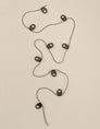 Black curtain track gliders on a cord