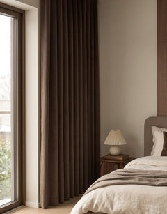 Brown velvet curtain in a bedroom with earthy colours